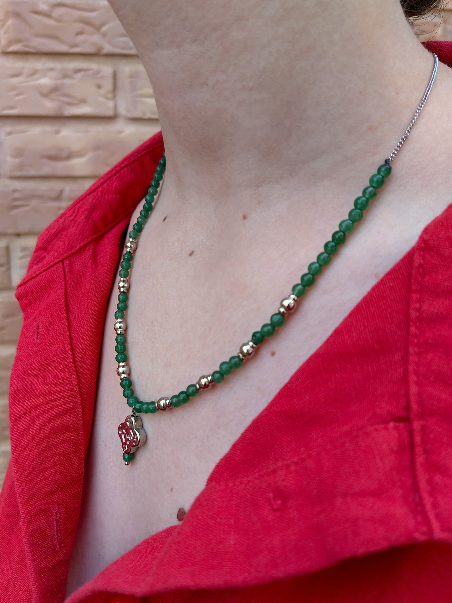 Collar de cuentas de piedra verdes y de metal plateadas. Con cadena y colgante abstracto plata.